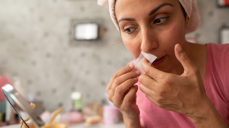 woman preparing to remove facial hair