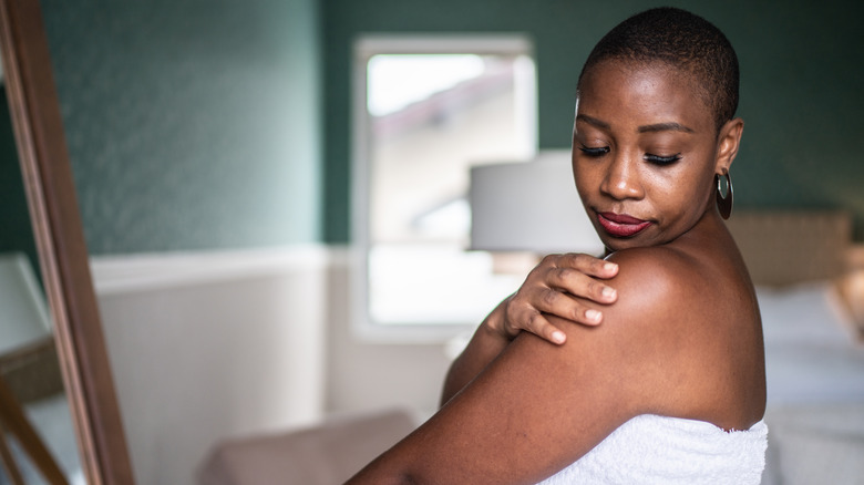 older woman touching arm 