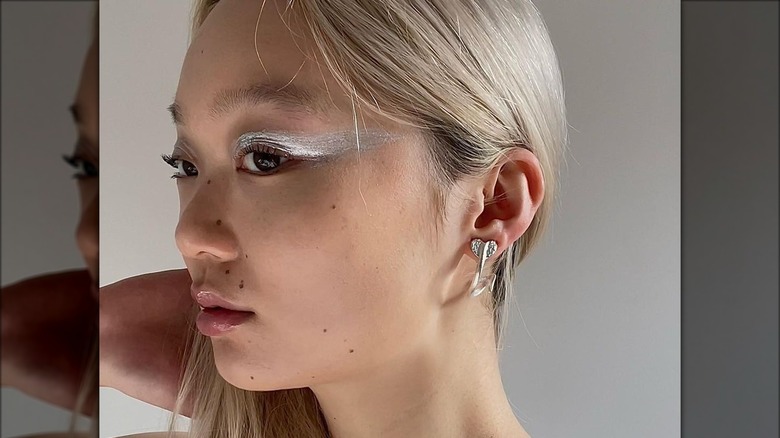 A woman with silver eyemakeup