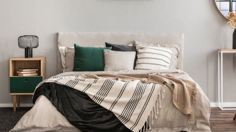 bed with linens and table