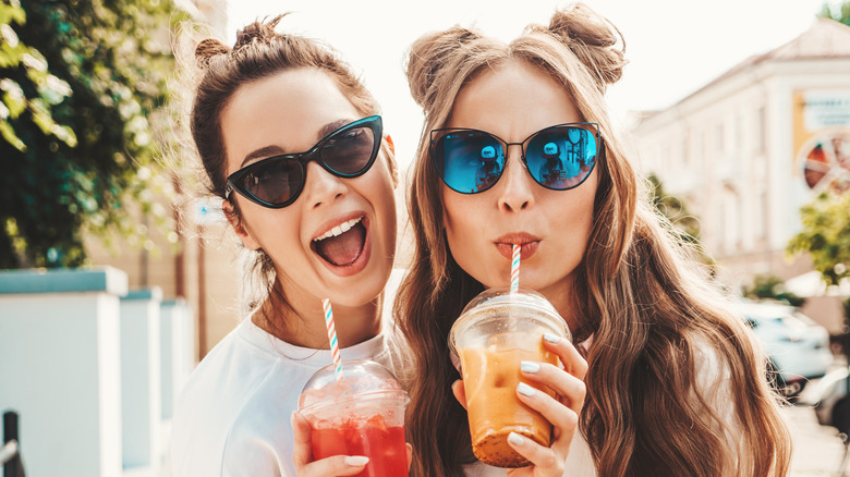 two friends drinking sodas