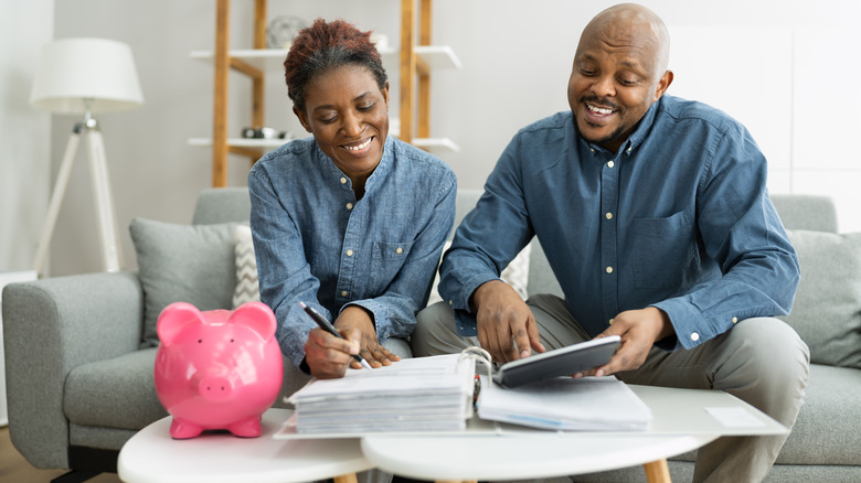 Couple smiling at calculator