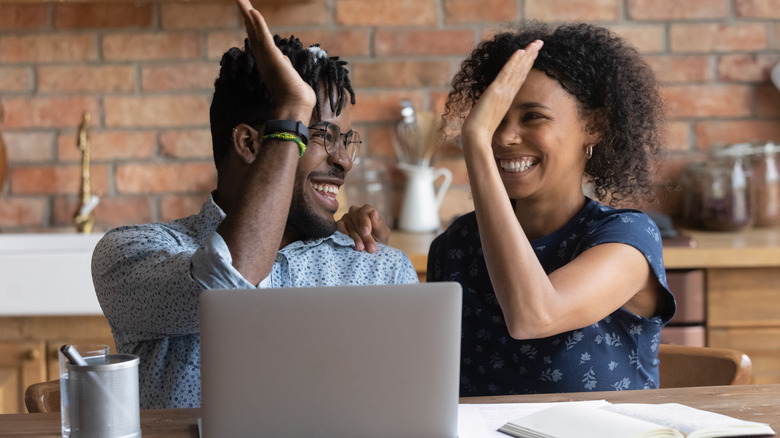 Couple high-fiving