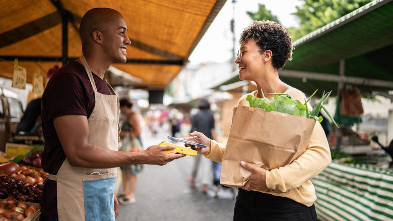 Man and woman speaking at outdoor food market