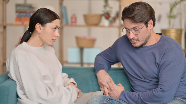 couple having conversation on couch