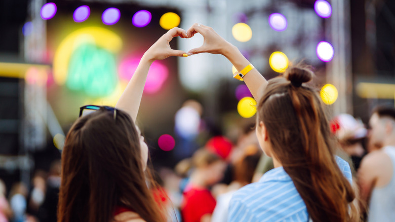 two women forming heart shape