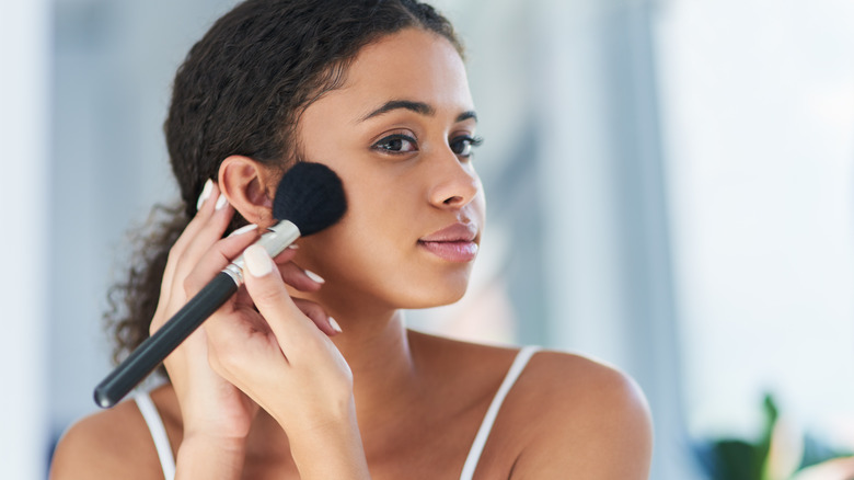 Woman applying finishing powder