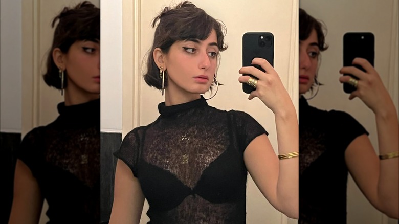 Rama Duwaji taking a mirror selfie wearing a sheer top