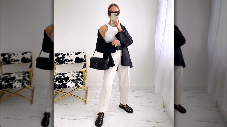 woman wearing white outfit, black blazer and fisherman sandals