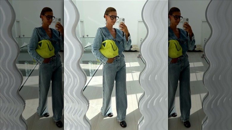 woman wearing denim outfit with black fisherman outfit