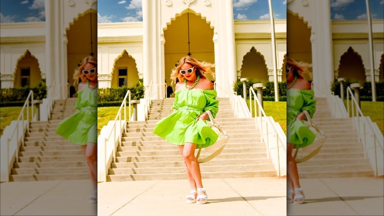 woman with green mini dress and white flatforms