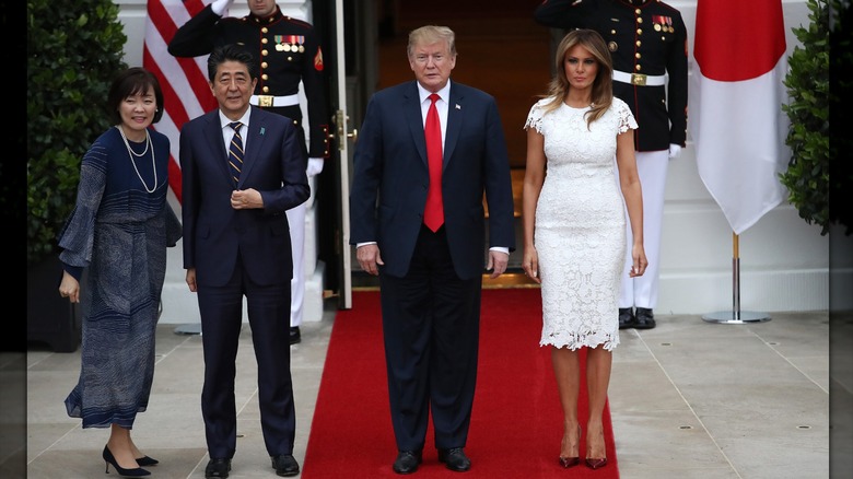 Melania Trump in a white lace dress with Donald Trump and the prime minister of Japan and his wife