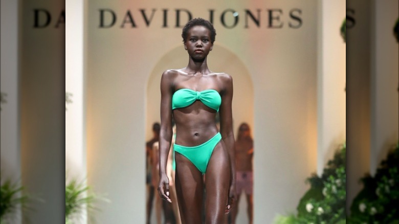 Adut Akechl wearing bright turquoise bikini