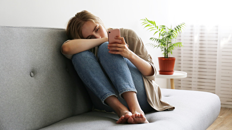 A sad woman on a phone