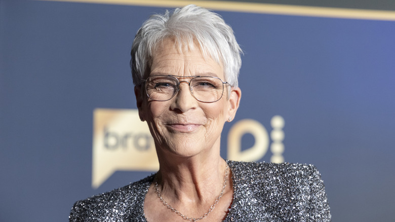Jamie Lee Curtis in a tweed blazer and glasses