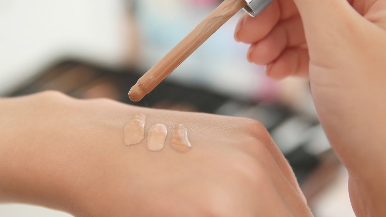 Testing foundation shades on back of hand