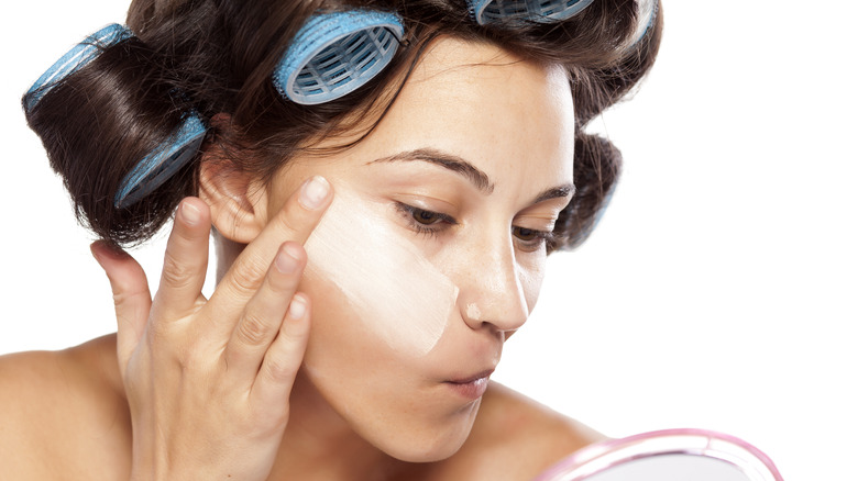 woman applying foundation with fingers