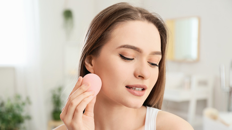 Woman blending her makeup