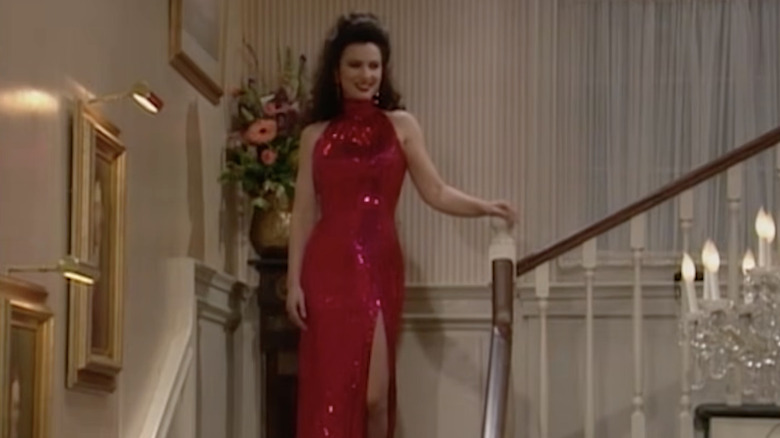 Fran Fine walks does a flight of stairs in a sequined red dress