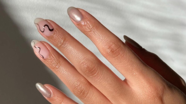 Hand with black freehand design