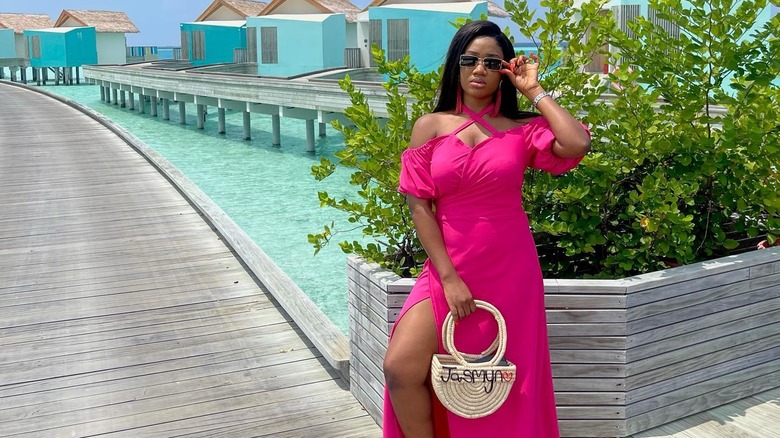 Woman carrying a raffia handbag