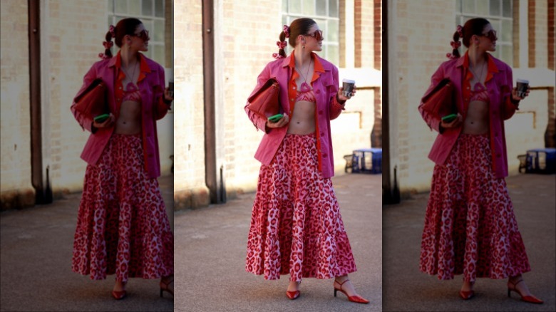 woman wearing a pink button up and leopard pink full skirt