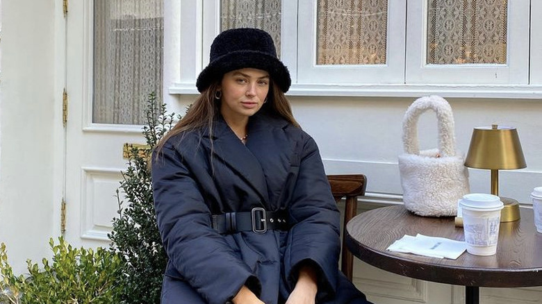 woman wearing hat and sitting outside 