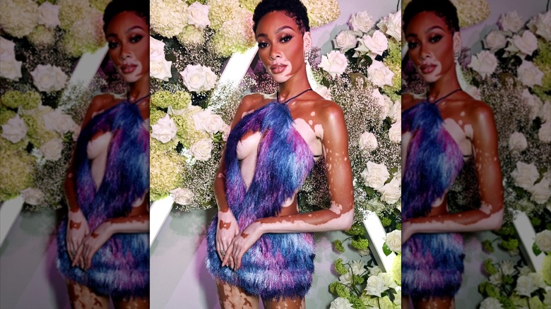 Winnie Harlow wearing fuzzy purple dress