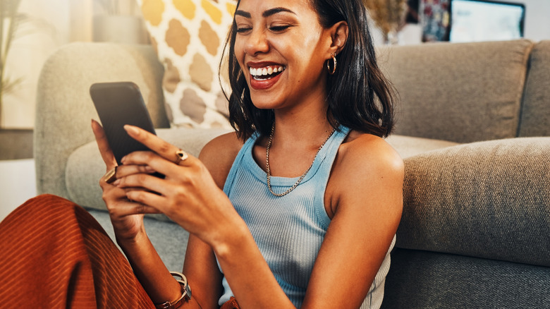 Woman texting and smiling