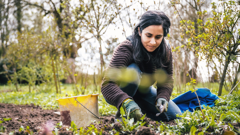 Woman kneeling in garden