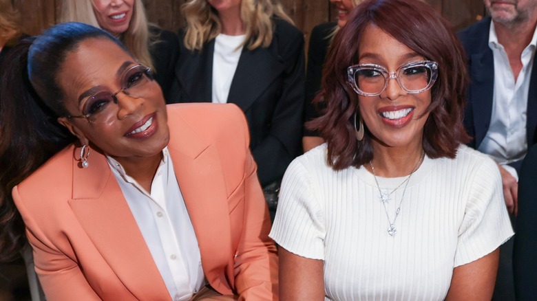 Oprah Winfrey and Gayle King sit side by side at a fashion show