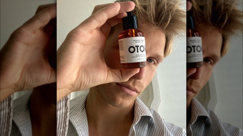 Man holding Noto Botanicals product