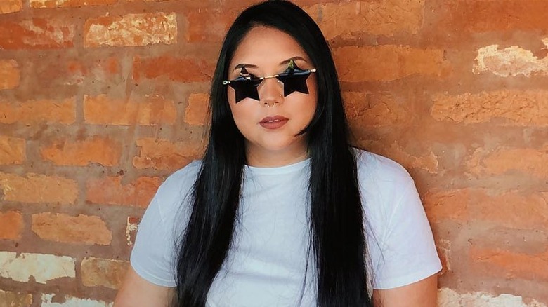 Woman wearing geometric sunglasses