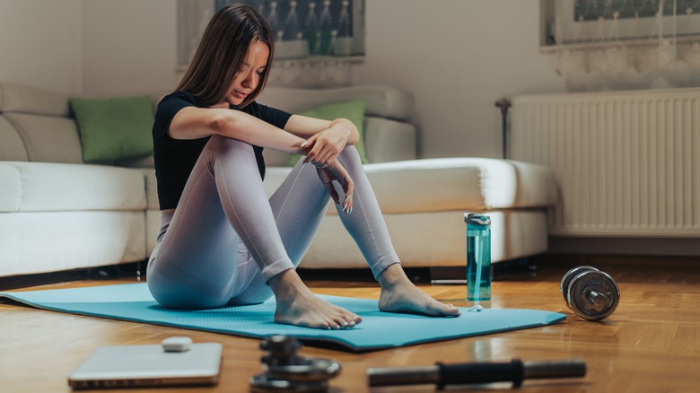 woman on yoga mat after workout