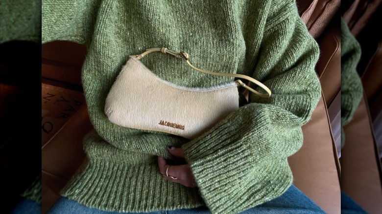 woman holding shoulder bag