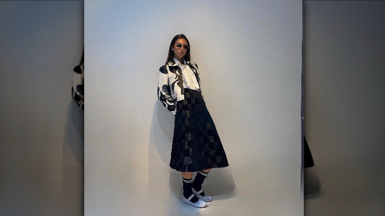 woman wearing midi skirt and leather jacket