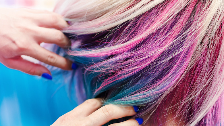 stylist with different colored hair