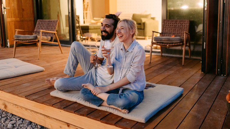 Man, woman drinking wine outside