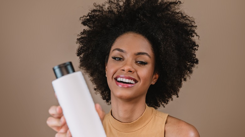 female flaunting hair mousse