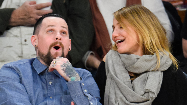 Benji Madden and Cameron Diaz attending a basketball game
