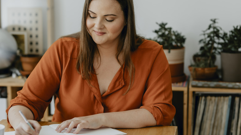 Woman writing in journal