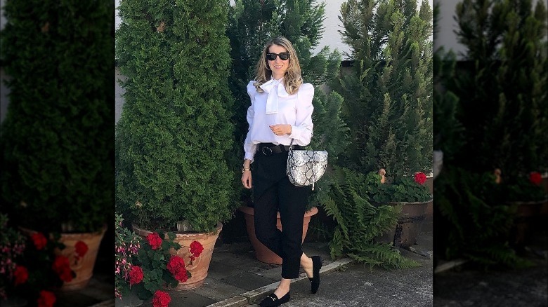 Woman wearing feminine blouse, pants