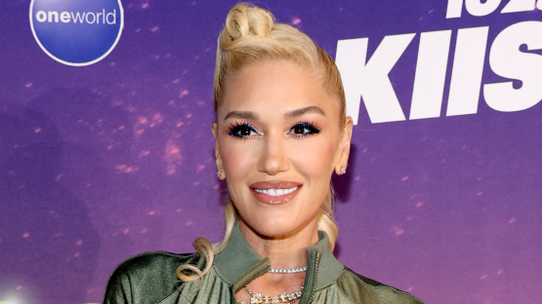 Gwen Stefani smiling with a blond updo
