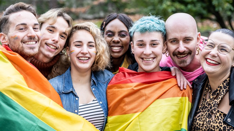 People holding LGBT flag