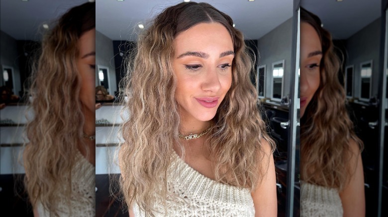 Woman with crimped hair and sleek bangs