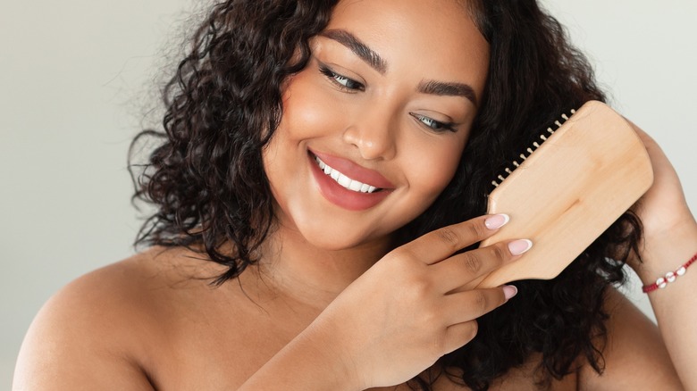 woman combs her hair
