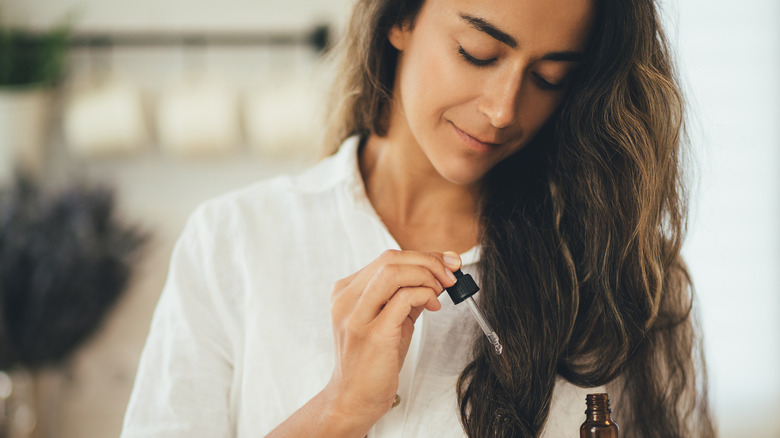 woman holding hair product