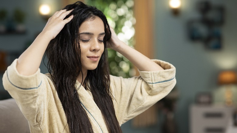 Woman giving herself a head massage