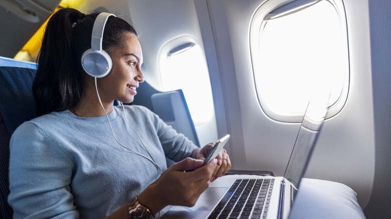 woman on plane with headphone