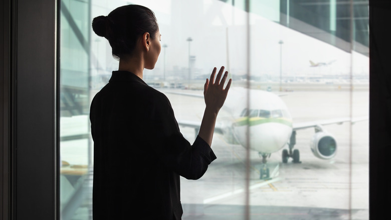 woman with mid-bun at airport